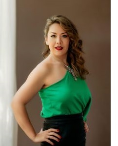 Nina Yoshida Nelson in green one shoulder top and black skirt.